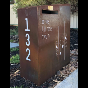 Custom Wide Form Letterbox with Raked Roof in Rusted Corten Steel with Perspex Backing